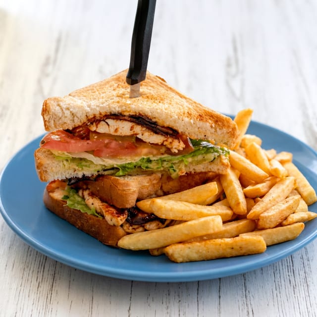 GRILLED CHICKEN CLUB SANDWICH.